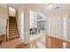 Bright foyer with hardwood floors, staircase, and a view into the formal dining area; naturally lit at 1135 Chandler Ridge Dr, Lawrenceville, GA 30045