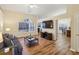 Cozy living room with wood flooring, neutral paint, and a view to the kitchen through an open archway at 1135 Chandler Ridge Dr, Lawrenceville, GA 30045