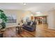 Comfortable living room flows into the kitchen, featuring a gray sofa and wood floors at 1135 Chandler Ridge Dr, Lawrenceville, GA 30045