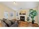 Comfortable living room with a gray sofa, fireplace, abstract art, and an abundance of natural light at 1135 Chandler Ridge Dr, Lawrenceville, GA 30045