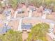 Aerial view of a neighborhood showcasing houses, driveways, and mature trees in a peaceful residential setting at 171 W Fork Way, Temple, GA 30179