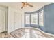 Blue accent bedroom featuring three windows for lots of natural light and wood flooring at 171 W Fork Way, Temple, GA 30179