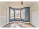 Blue accent bedroom featuring three windows for lots of natural light and wood flooring at 171 W Fork Way, Temple, GA 30179