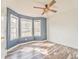 Blue accent bedroom featuring three windows for lots of natural light and wood flooring at 171 W Fork Way, Temple, GA 30179