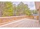 Spacious wooden deck with railings overlooking a lush, wooded backyard and perfect for outdoor entertaining at 171 W Fork Way, Temple, GA 30179