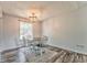 Bright dining room has a modern chandelier and wood floors at 171 W Fork Way, Temple, GA 30179