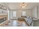 Bright living room with wood floors, a stone fireplace, and neutral decor at 171 W Fork Way, Temple, GA 30179