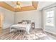 Bright main bedroom with neutral tones and tray ceiling detail at 171 W Fork Way, Temple, GA 30179