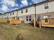 Townhome backyard featuring a wooden deck and privacy fence with brick and siding exterior under a cloudy sky at 312 Shine Dr, Stockbridge, GA 30281