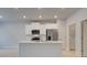 Well-lit kitchen with stainless steel appliances, island, and stylish white cabinetry at 312 Shine Dr, Stockbridge, GA 30281