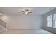 Spacious living room featuring stairs, a ceiling fan and a window at 312 Shine Dr, Stockbridge, GA 30281