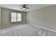 Bright bedroom with a ceiling fan, soft carpet, two windows, and neutral paint at 5990 Somerset Ct, Suwanee, GA 30024