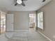 Spacious bedroom featuring soft carpet, neutral walls, and a view into the ensuite bathroom at 5990 Somerset Ct, Suwanee, GA 30024