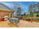 Outdoor deck features a table and chairs for outdoor entertaining and a stainless steel gas grill at 5990 Somerset Ct, Suwanee, GA 30024