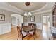 Elegant dining room showcasing hardwood floors, wainscoting, a chandelier and neutral paint at 5990 Somerset Ct, Suwanee, GA 30024