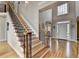 Grand foyer with hardwood floors, staircase with iron spindles, and ample natural light at 5990 Somerset Ct, Suwanee, GA 30024