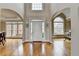 Elegant foyer with gleaming hardwood floors, arched entryways, and a high ceiling at 5990 Somerset Ct, Suwanee, GA 30024