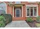 Charming brick home with a welcoming front porch and neatly trimmed landscaping at 5990 Somerset Ct, Suwanee, GA 30024