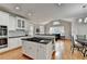 Bright kitchen featuring white cabinetry, granite countertops, stainless steel appliances, and hardwood floors at 5990 Somerset Ct, Suwanee, GA 30024