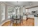 Eat-in kitchen with hardwood floors, an adjacent dining nook and many windows at 5990 Somerset Ct, Suwanee, GA 30024