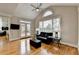 Bright living room with hardwood floors, vaulted ceiling, and access to the outdoor deck through french doors at 5990 Somerset Ct, Suwanee, GA 30024