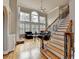 Bright living room with hardwood floors, fireplace, and large windows with shutter-style blinds at 5990 Somerset Ct, Suwanee, GA 30024