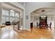 Cozy living room with a staircase, hardwood floors, and view into the dining room at 5990 Somerset Ct, Suwanee, GA 30024