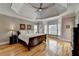 Spacious main bedroom with hardwood floors, tray ceiling, and a bay window providing plenty of natural light at 5990 Somerset Ct, Suwanee, GA 30024