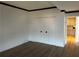 Comfortable bedroom with hardwood flooring, neutral walls, white closet doors, and entrance to kitchen at 145 15Th St # Apt 1023, Atlanta, GA 30309