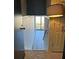 View of the hallway with neutral walls leading to a glass door overlooking trees and foliage at 145 15Th St # Apt 1023, Atlanta, GA 30309