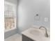 Well-lit bathroom featuring a modern vanity, sleek faucet, and a window providing natural light and a view at 4391 Chatuge Dr, Buford, GA 30519