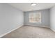 Bright bedroom with neutral carpet and paint, with a window letting in natural light at 4391 Chatuge Dr, Buford, GA 30519