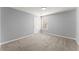 Inviting bedroom with neutral walls, soft carpet, and a window offering natural light, creating a peaceful retreat at 4391 Chatuge Dr, Buford, GA 30519