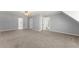 Spacious bonus room with a neutral palette, plush carpet, and multiple doorways leading to other areas of the house at 4391 Chatuge Dr, Buford, GA 30519