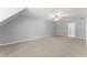 Expansive bonus room with plush carpet, neutral walls, and a ceiling fan, perfect for relaxation or entertainment at 4391 Chatuge Dr, Buford, GA 30519