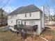 Back of house with stairs leading to wooden deck, with neutral colored siding at 4391 Chatuge Dr, Buford, GA 30519