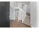 Bright foyer showcasing hardwood floors and an elegant staircase at 4391 Chatuge Dr, Buford, GA 30519