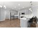 Modern kitchen with stainless appliances, bar seating and wood floors at 4391 Chatuge Dr, Buford, GA 30519