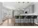 Bright kitchen with bar seating, stainless steel appliances, and hardwood floors at 4391 Chatuge Dr, Buford, GA 30519