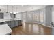 Bright kitchen features stainless appliances, quartz countertops, and wood floors at 4391 Chatuge Dr, Buford, GA 30519