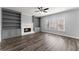 Spacious living room with built-in shelving, fireplace, and wood floors at 4391 Chatuge Dr, Buford, GA 30519