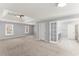 Open main bedroom with a ceiling fan, windows, and bathroom access providing light and convenience at 4391 Chatuge Dr, Buford, GA 30519