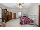 Bedroom with white walls, grandfather clock, and bed with floral patterned cover at 113 Bridget Dr, Hampton, GA 30228