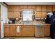 Traditional kitchen features wood cabinetry, stainless steel dishwasher and double basin sink at 113 Bridget Dr, Hampton, GA 30228