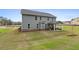 Backyard view featuring a covered patio with outdoor seating and a well-maintained lawn at 120 Felicity Pike, Locust Grove, GA 30248