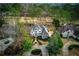 An aerial view of a home nestled in a community with a lush canopy of mature trees and landscaping at 2011 Palmetto Dunes Ct, Johns Creek, GA 30097