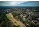 Sweeping aerial shot of a home overlooking a pristine golf course in a community surrounded by mature trees at 2011 Palmetto Dunes Ct, Johns Creek, GA 30097