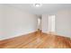 Neutral bedroom featuring pristine hardwood floors, white walls, and ample space at 3811 Harts Mill Ne Ln, Brookhaven, GA 30319