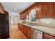 Modern kitchen with wood cabinets, stainless steel appliances, granite counters, and hardwood floors at 3811 Harts Mill Ne Ln, Brookhaven, GA 30319