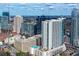 Stunning aerial view showcasing the building with beautiful city skyline and blue skies at 860 Peachtree Ne St # 1008, Atlanta, GA 30308